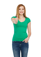 Image showing smiling teenage girl showing thumbs up