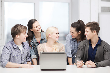 Image showing smiling students with laptop at school