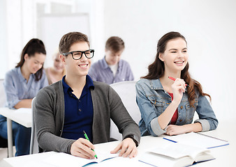 Image showing smiling students with notebooks at school