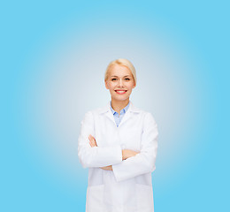 Image showing smiling female doctor over blue background