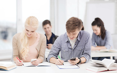 Image showing students looking into smartphone at school