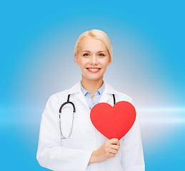 Image showing smiling female doctor with heart and stethoscope