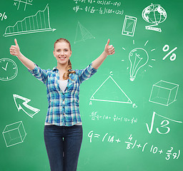 Image showing smiling student girl showing thumbs up