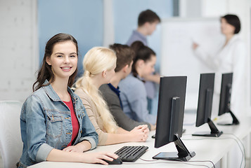 Image showing smiling teenage girl with classmates and teacher