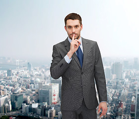 Image showing young businessman making hush sign