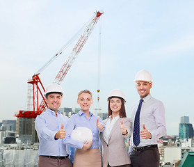 Image showing group of smiling businessmen in white helmets