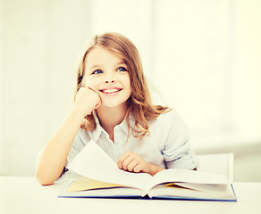 Image showing little student girl studying at school