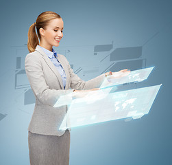 Image showing smiling businesswoman working with virtual screens