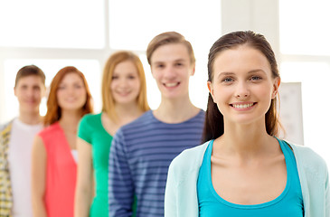 Image showing smiling students with teenage girl in front