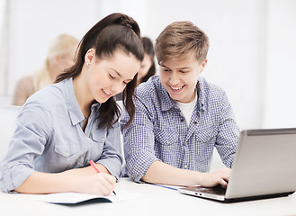 Image showing students with laptop and notebooks at school