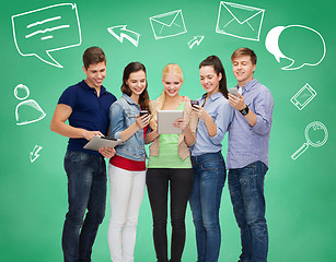 Image showing smiling students with tablet pcs and smartphones