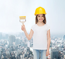 Image showing smiling little girl in helmet with paint brush