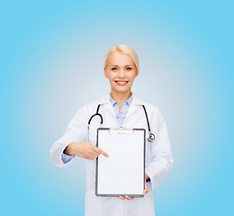 Image showing smiling female doctor with clipboard