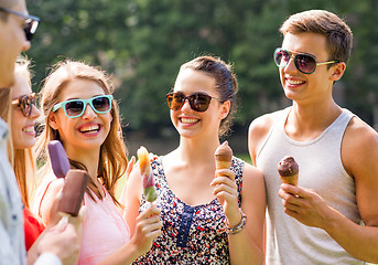 Image showing group of smiling friends with ice cream outdoors