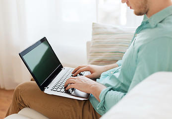 Image showing close up of man working with laptop at home