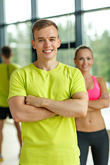 Image showing smiling man and woman in gym