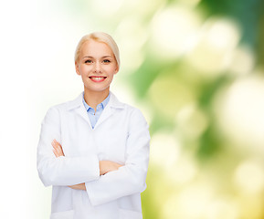 Image showing smiling female doctor over natural background