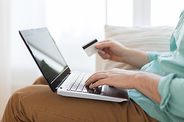 Image showing close up of man with laptop and credit card