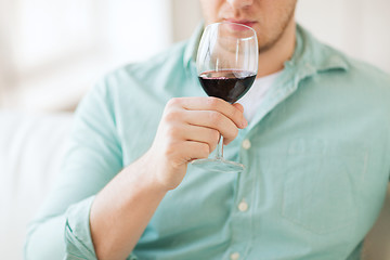 Image showing close up of man drinking wine at home