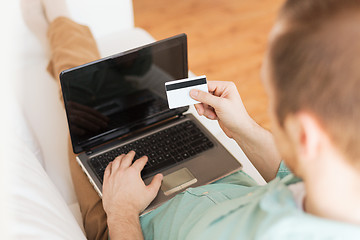 Image showing close up of man with laptop and credit card