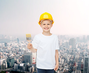 Image showing smiling little girl in helmet with paint brush