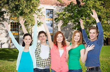 Image showing group of smiling students waving hands