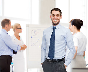 Image showing group of smiling businessmen with smartboard