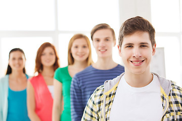 Image showing smiling male student with group of classmates