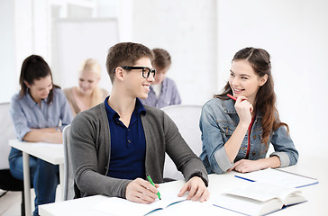 Image showing smiling students with notebooks at school