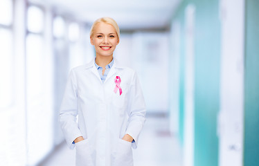 Image showing smiling female doctor with cancer awareness ribbon