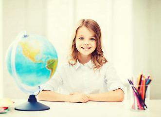 Image showing student girl with globe at school