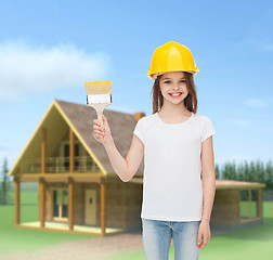 Image showing smiling little girl in helmet with paint brush