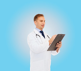 Image showing smiling male doctor with clipboard and stethoscope