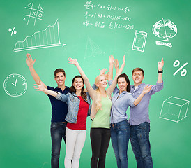 Image showing group of smiling students over green board