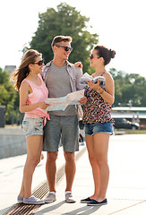 Image showing smiling friends with map and city guide outdoors