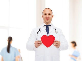 Image showing smiling male doctor with red heart and stethoscope