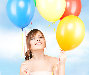 Image showing happy teenage girl with balloons