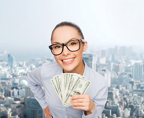 Image showing smiling businesswoman with dollar cash money