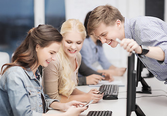 Image showing students with computer monitor and smartphones