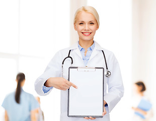 Image showing smiling female doctor with clipboard