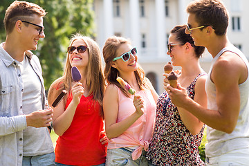 Image showing group of smiling friends with ice cream outdoors