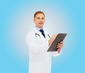 Image showing smiling male doctor with clipboard and stethoscope