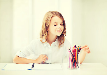 Image showing girl drawing with pencils at school