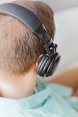 Image showing close up of man in headphones at home