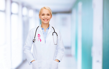 Image showing doctor with stethoscope, cancer awareness ribbon