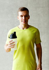 Image showing smiling man with protein shake bottle