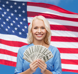 Image showing smiling young woman with us dollar money