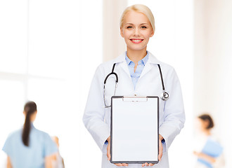 Image showing smiling female doctor with clipboard