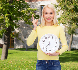 Image showing student with wall clock and finger up