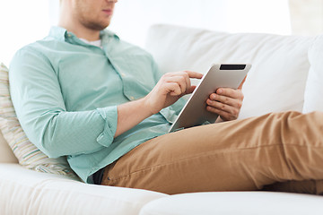 Image showing close up of man with tablet pc computer at home